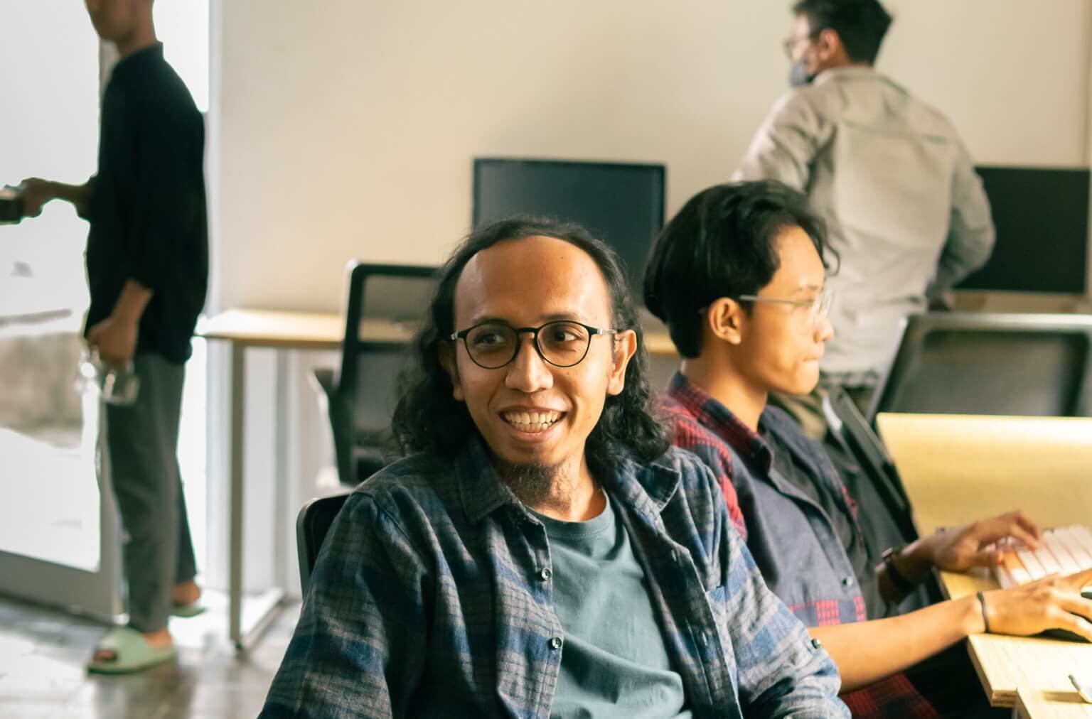Ali Mashuri at work with a colleague